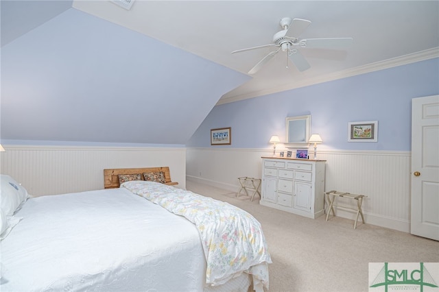 bedroom featuring a wainscoted wall, ceiling fan, carpet, and vaulted ceiling