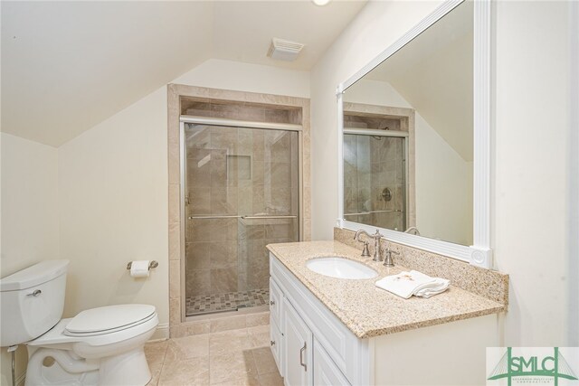 bathroom featuring visible vents, vanity, toilet, a shower stall, and vaulted ceiling
