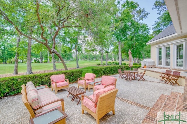view of patio / terrace featuring grilling area, outdoor dining area, and an outdoor hangout area