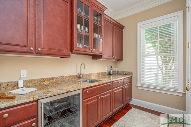 bar with beverage cooler, dark wood-style floors, plenty of natural light, a sink, and wet bar