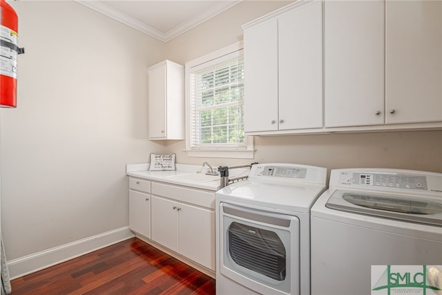 washroom featuring a sink, ornamental molding, dark wood-type flooring, and washer and clothes dryer