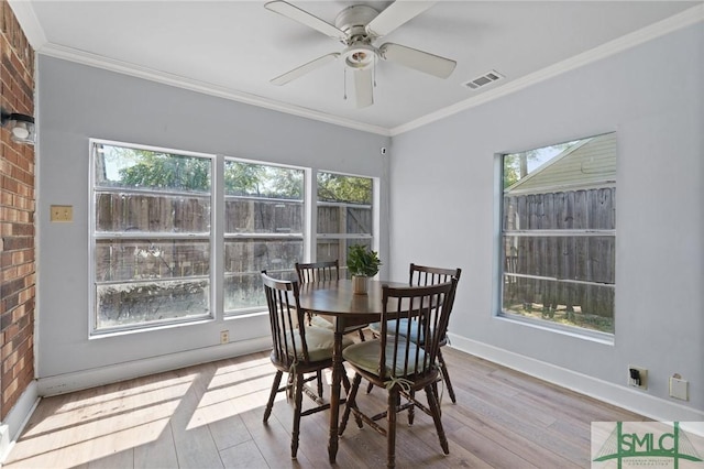 121 Pelican Ln, Richmond Hill, GA 31324 - dining room with visible vents, wood finished floors, and a healthy amount of sunlight