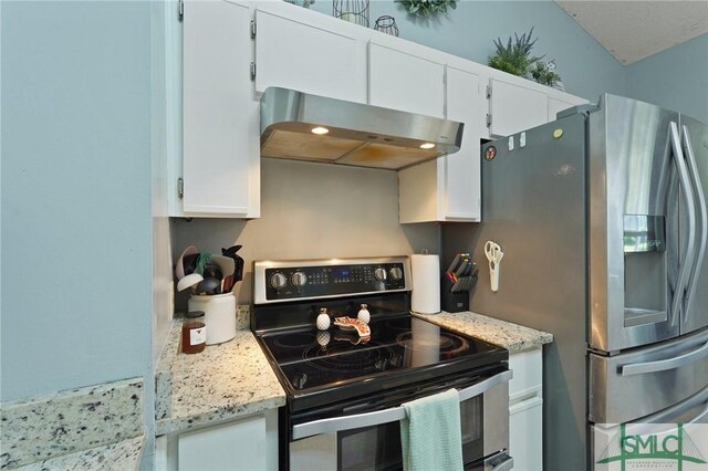 121 Pelican Ln, Richmond Hill, GA 31324 - kitchen featuring light stone counters, appliances with stainless steel finishes, white cabinets, and extractor fan