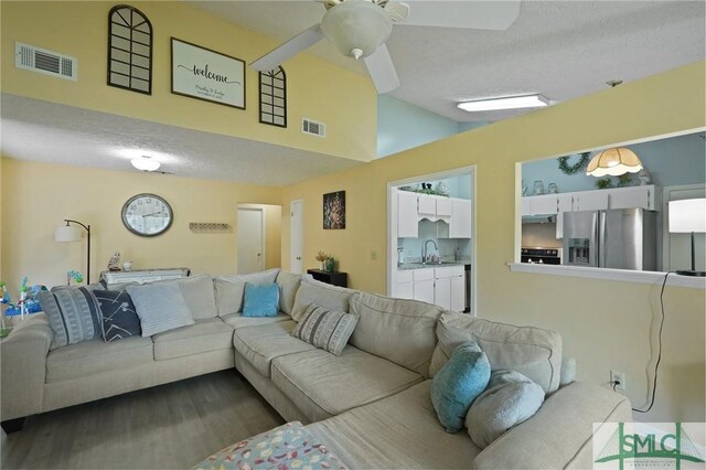 121 Pelican Ln, Richmond Hill, GA 31324 - living area with ceiling fan, lofted ceiling, dark wood finished floors, and visible vents