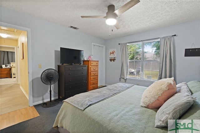121 Pelican Ln, Richmond Hill, GA 31324 - bedroom featuring visible vents, attic access, a textured ceiling, and baseboards