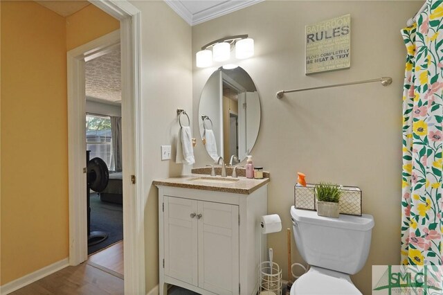121 Pelican Ln, Richmond Hill, GA 31324 - bathroom with vanity, ornamental molding, wood finished floors, toilet, and baseboards