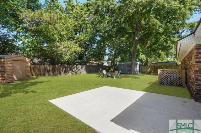 121 Pelican Ln, Richmond Hill, GA 31324 - view of yard featuring a patio, an outbuilding, a shed, and a fenced backyard