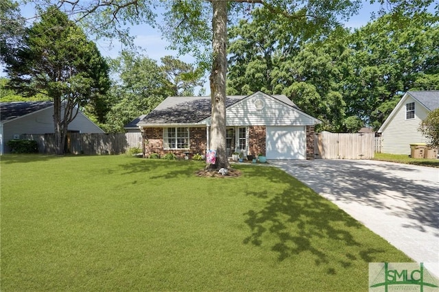 121 Pelican Ln, Richmond Hill, GA 31324 - view of front of home with brick siding, a front lawn, fence, and driveway