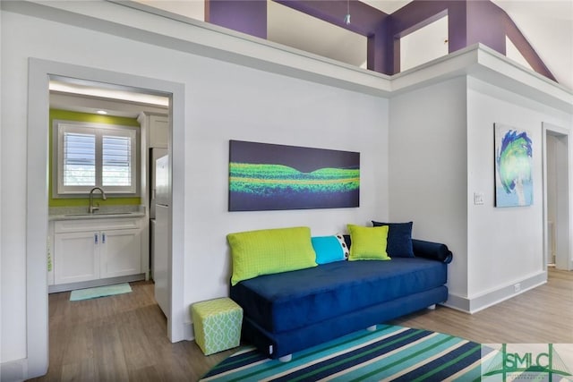 living room with baseboards and wood finished floors