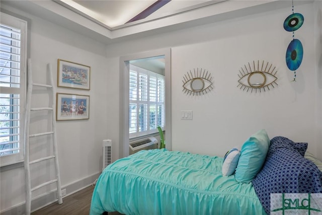 bedroom featuring baseboards and dark wood-style floors