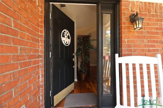 property entrance featuring brick siding