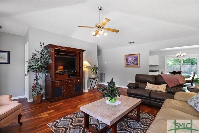 living area with vaulted ceiling, ceiling fan with notable chandelier, dark wood finished floors, and visible vents