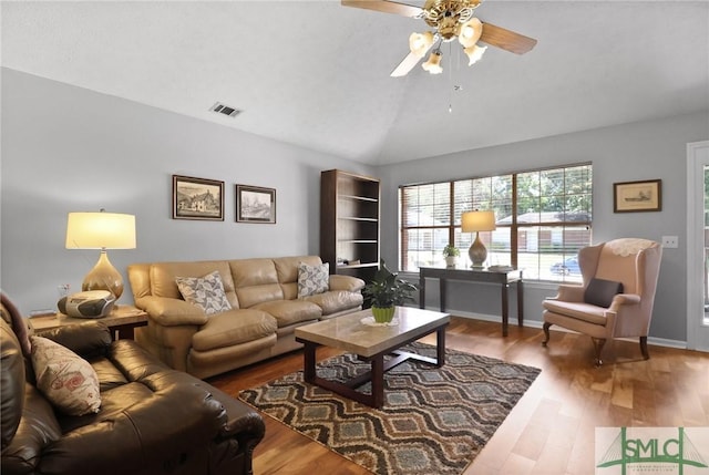 living room featuring ceiling fan, lofted ceiling, wood finished floors, and visible vents