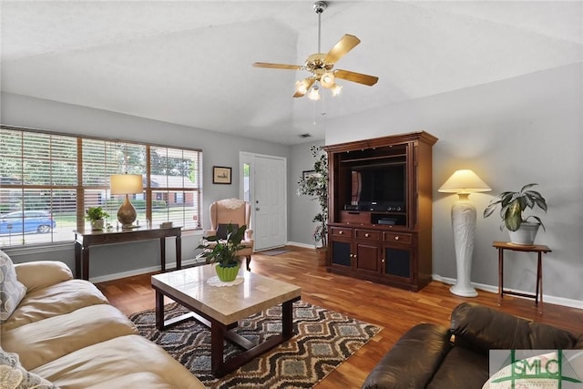 living area featuring ceiling fan, baseboards, lofted ceiling, and wood finished floors