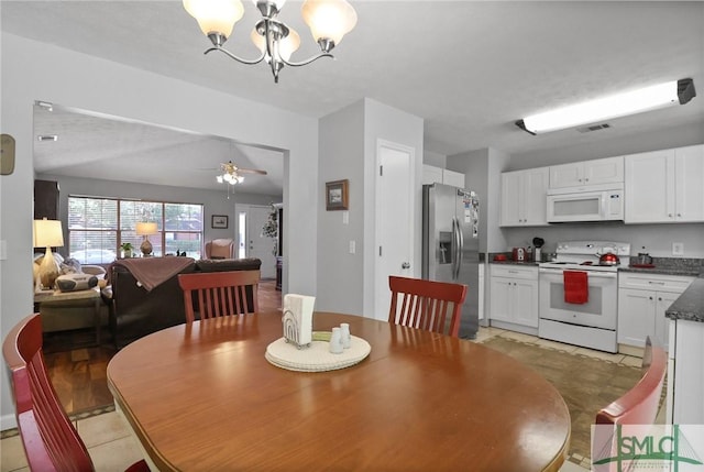 dining room featuring visible vents and ceiling fan with notable chandelier