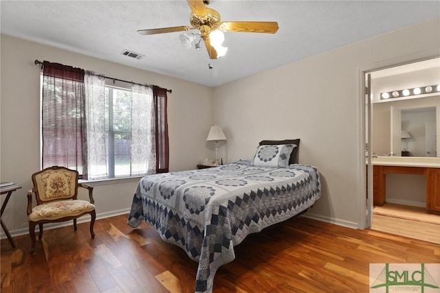 bedroom with light wood finished floors, ensuite bath, a ceiling fan, baseboards, and visible vents