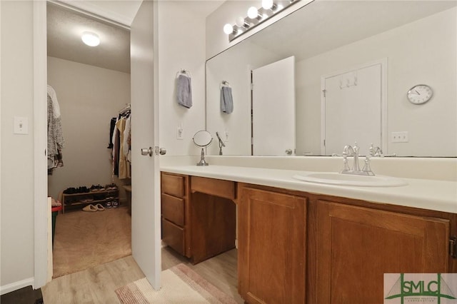 bathroom with wood finished floors and vanity
