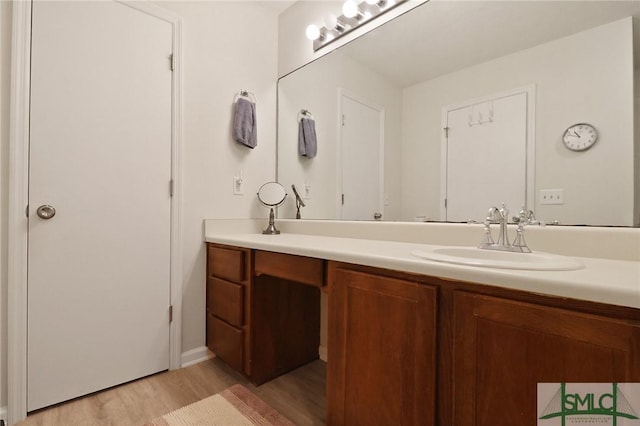 bathroom featuring vanity and wood finished floors