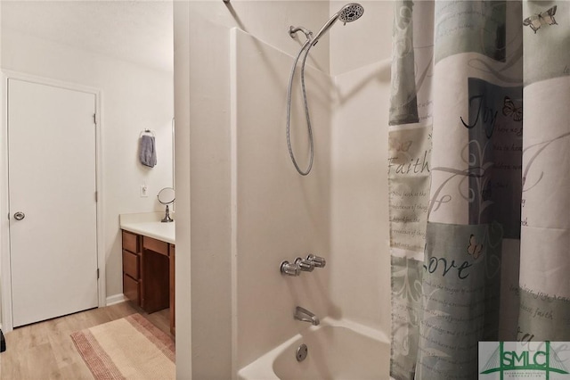 bathroom featuring vanity, wood finished floors, and shower / tub combo