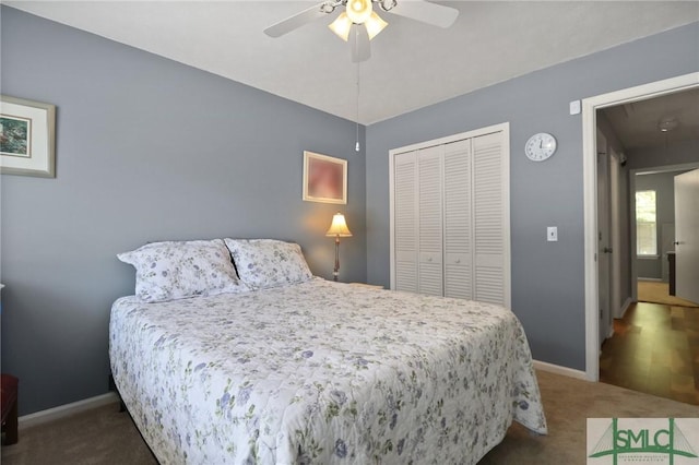 carpeted bedroom with baseboards, a ceiling fan, a closet, and attic access