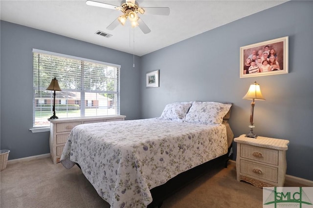 bedroom featuring visible vents, baseboards, light carpet, and multiple windows