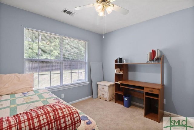 bedroom featuring light colored carpet, baseboards, visible vents, and ceiling fan