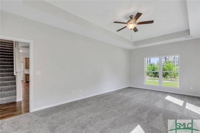 291 Cromer St, Savannah, GA 31407 - empty room with ceiling fan, stairway, a raised ceiling, baseboards, and carpet