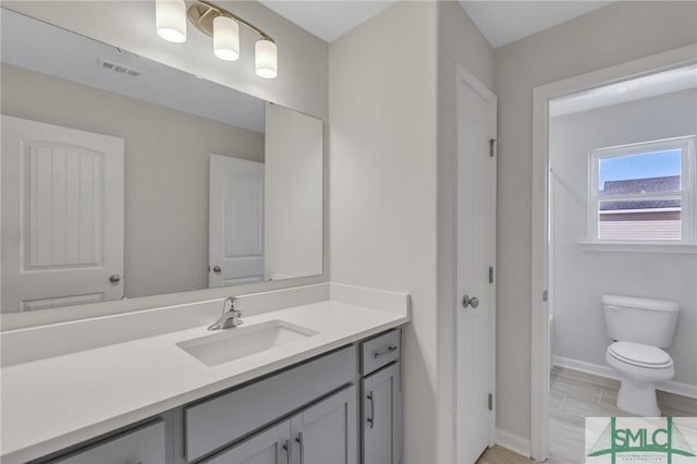 291 Cromer St, Savannah, GA 31407 - bathroom featuring toilet, baseboards, visible vents, and vanity