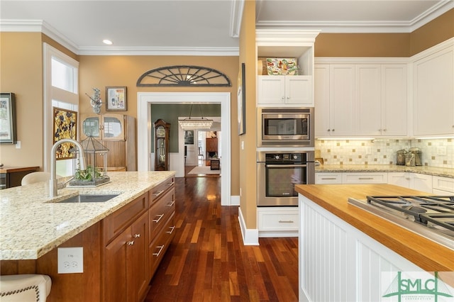 kitchen featuring a sink, dark wood-style flooring, white cabinetry, and stainless steel appliances