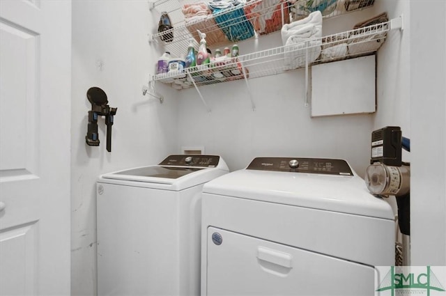 laundry room with laundry area and washing machine and clothes dryer