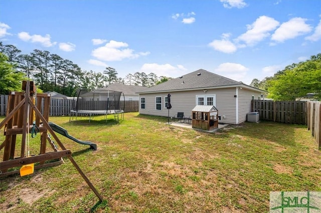back of house featuring a playground, a trampoline, a lawn, and a patio