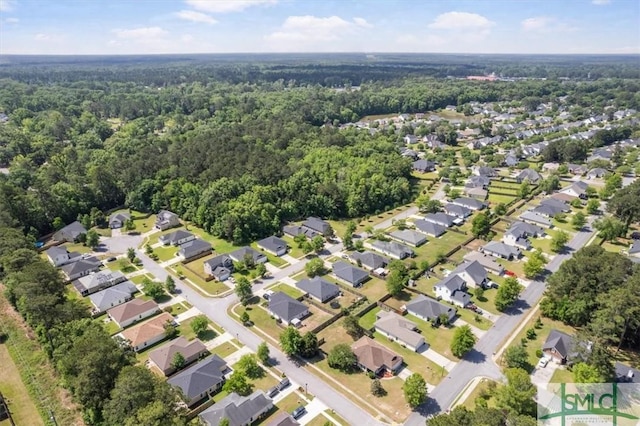 bird's eye view featuring a residential view and a wooded view