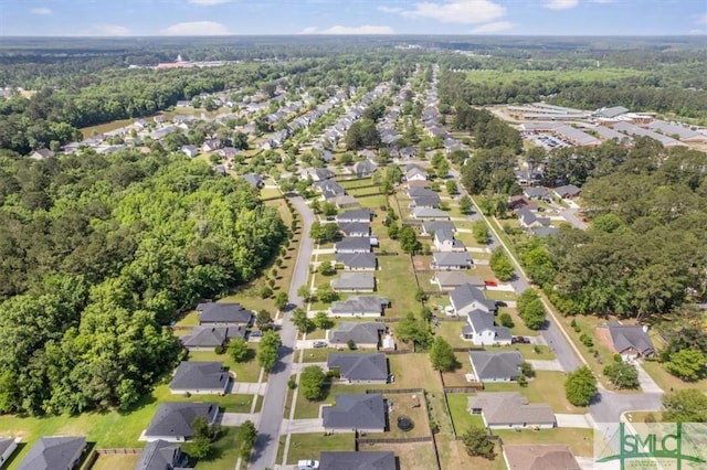 drone / aerial view featuring a residential view and a view of trees