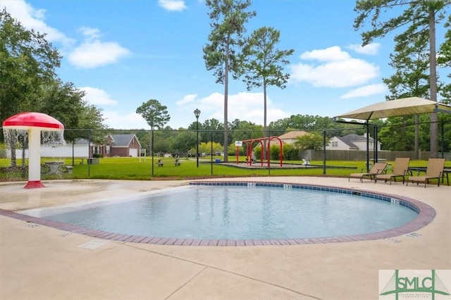 pool with a lawn and fence