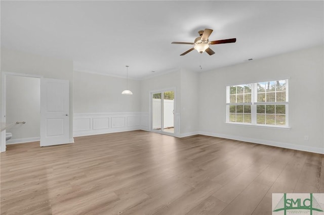 446 Governor Treutlen Cir Unit 22, Pooler, GA 31322 - unfurnished living room featuring a ceiling fan, wainscoting, and light wood-style flooring
