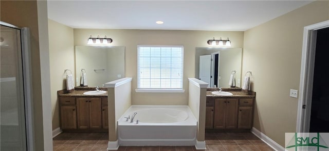 14 Canterbury Rd NE, Ludowici, GA 31316 - full bath with tile patterned floors, a sink, a bath, and a stall shower