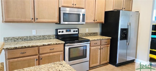 14 Canterbury Rd NE, Ludowici, GA 31316 - kitchen with light tile patterned floors, appliances with stainless steel finishes, light brown cabinetry, and light stone countertops