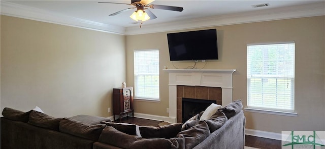 14 Canterbury Rd NE, Ludowici, GA 31316 - living room with crown molding, dark wood-style flooring, a ceiling fan, baseboards, and visible vents