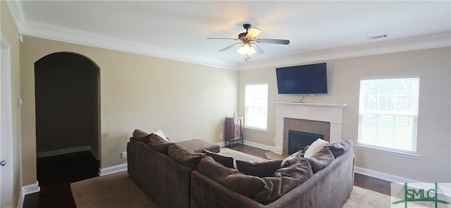 14 Canterbury Rd NE, Ludowici, GA 31316 - living area featuring ceiling fan, visible vents, arched walkways, a tile fireplace, and ornamental molding