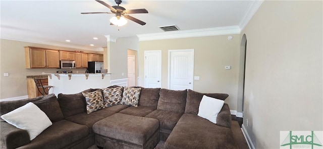 14 Canterbury Rd NE, Ludowici, GA 31316 - living room with crown molding, baseboards, ceiling fan, and visible vents