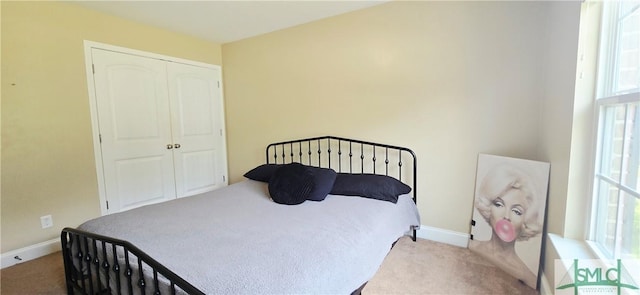 14 Canterbury Rd NE, Ludowici, GA 31316 - carpeted bedroom with a closet, baseboards, and multiple windows