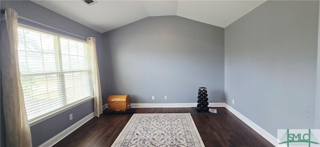 14 Canterbury Rd NE, Ludowici, GA 31316 - empty room featuring baseboards, dark wood-type flooring, lofted ceiling, and visible vents