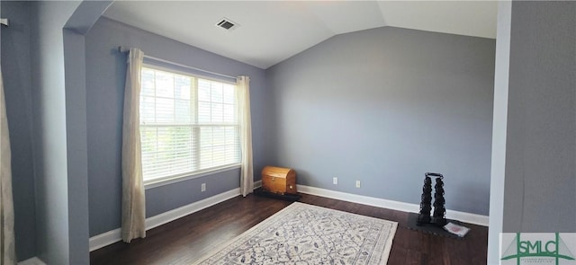 14 Canterbury Rd NE, Ludowici, GA 31316 - interior space featuring visible vents, baseboards, dark wood finished floors, and lofted ceiling