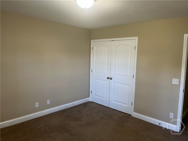 14 Canterbury Rd NE, Ludowici, GA 31316 - unfurnished bedroom featuring dark colored carpet and a closet