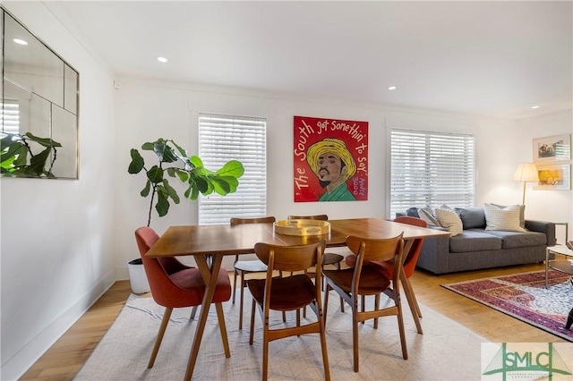 dining room with ornamental molding, recessed lighting, and light wood-style flooring