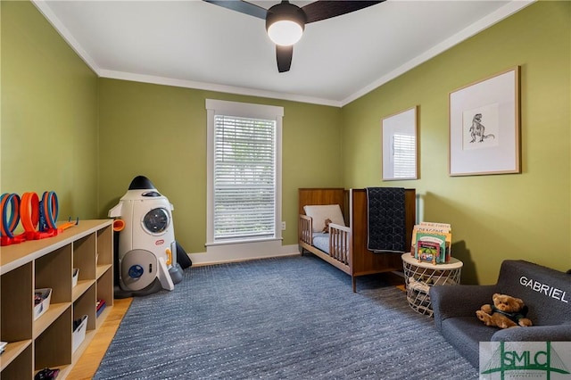 playroom with a ceiling fan, baseboards, and ornamental molding