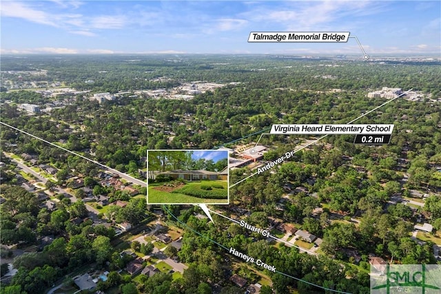 bird's eye view with a wooded view