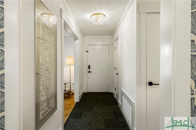 doorway to outside with visible vents and a chandelier