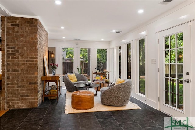 sunroom / solarium with recessed lighting, brick wall, visible vents, and french doors