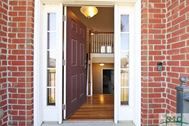 doorway to property featuring brick siding